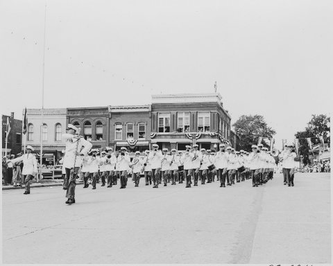 A band passing in formation before the reviewing stand (not visible) on which President Harry S. Truman is seated, in..…