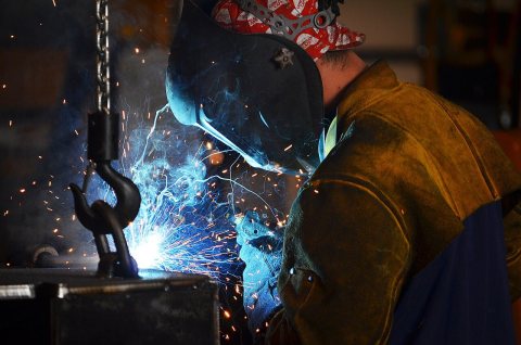Worker in Fulton, Missouri welds a part of a truck on Sept. 22, 2015