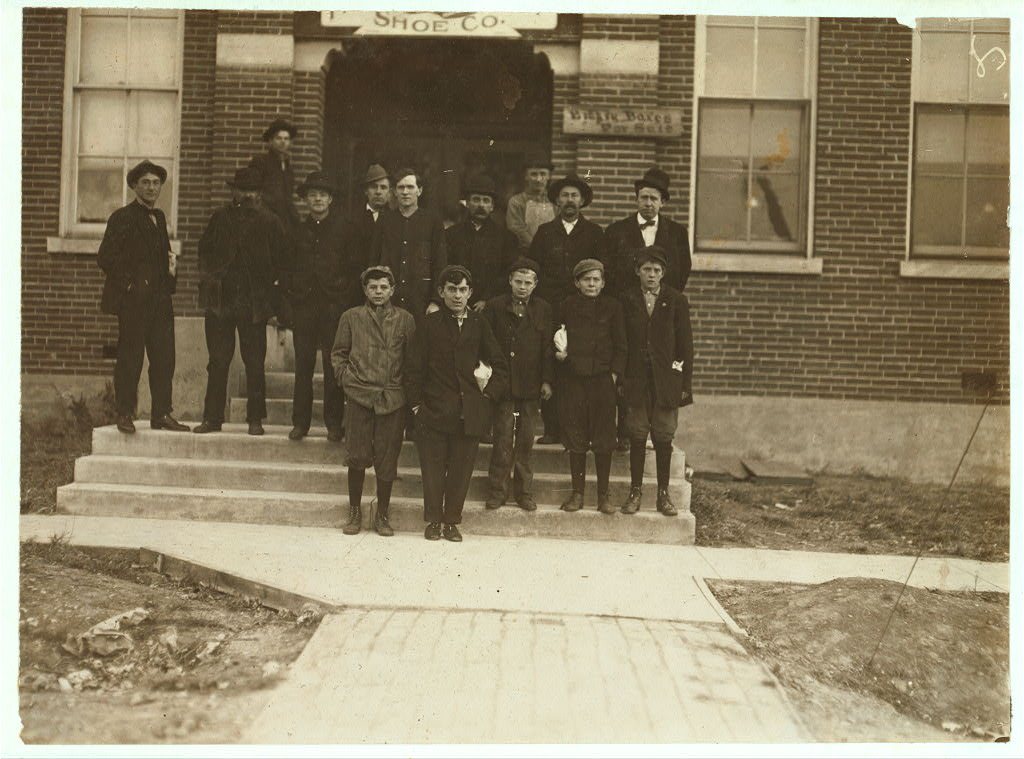 Group of boys working in Friedman Shelby Shoe Co., 6:30 A.M. The youngest, Vehnie Hughes, said he was 12 years old and …