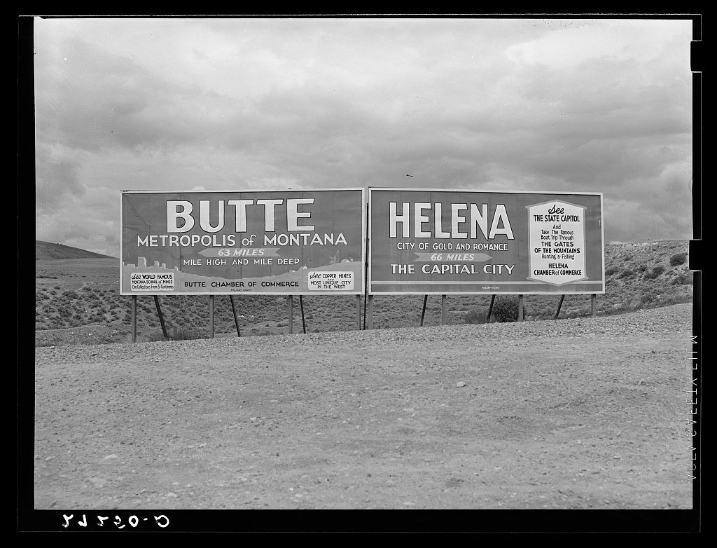 Signs at highway intersection. Three Forks, Montana