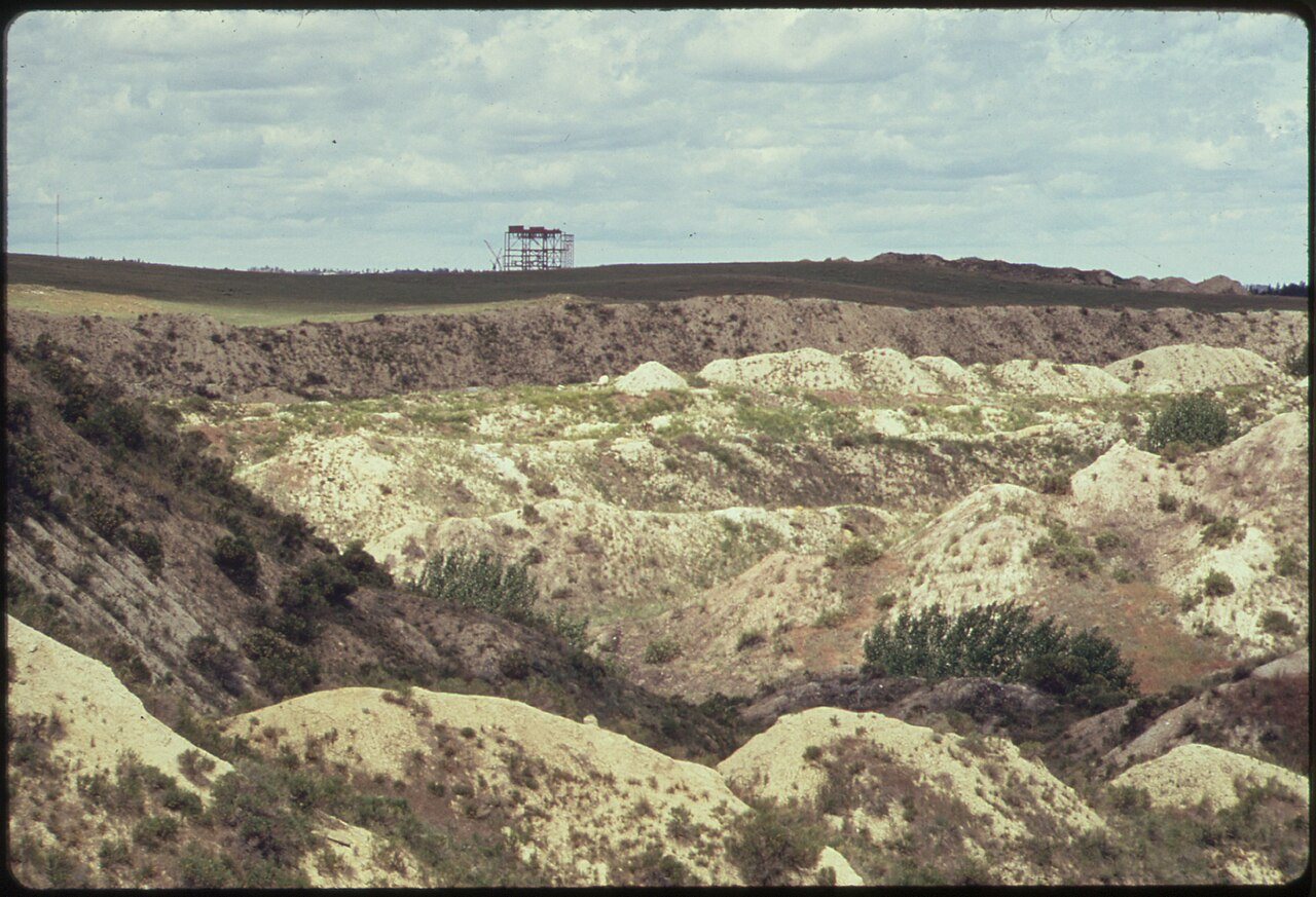 A 350 MEGAWATT POWER PLANT UNDER CONSTRUCTION AT COLSTRIP OVERLOOKS 20-YEAR OLD STRIP MINE SPOIL PILES