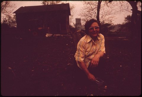 MRS. ART SCHAEFER OF GARLAND PLANTS HER SPRING GARDEN
