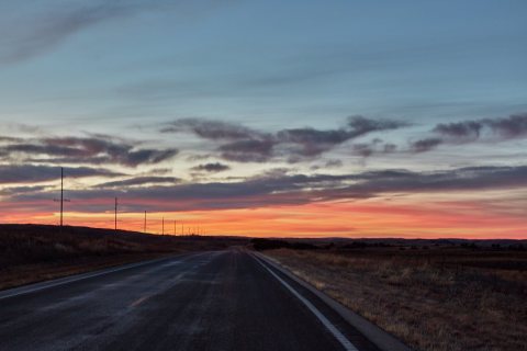 Dusk settles across a road through the vast Nebraska sandhills, near Mullen in Hooker County