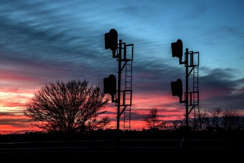 Dusk view of trackside train signals near Mullen in the Nebraska sandhills