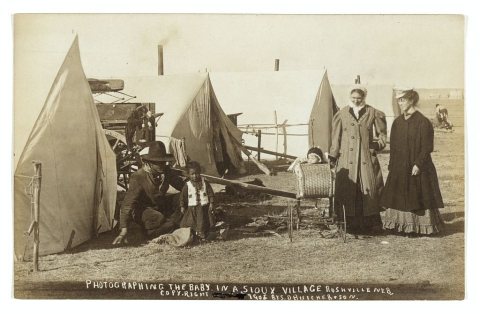 Photographing the baby in a Sioux village