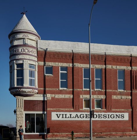 A downtown building with a handsome, turreted bay window