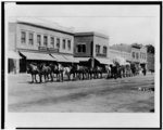 Wagon train on Main Street, in front of Hotel Western