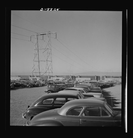Production. Magnesium. Workers' cars parked under a section of the high-tension transmission lines which bring electric…