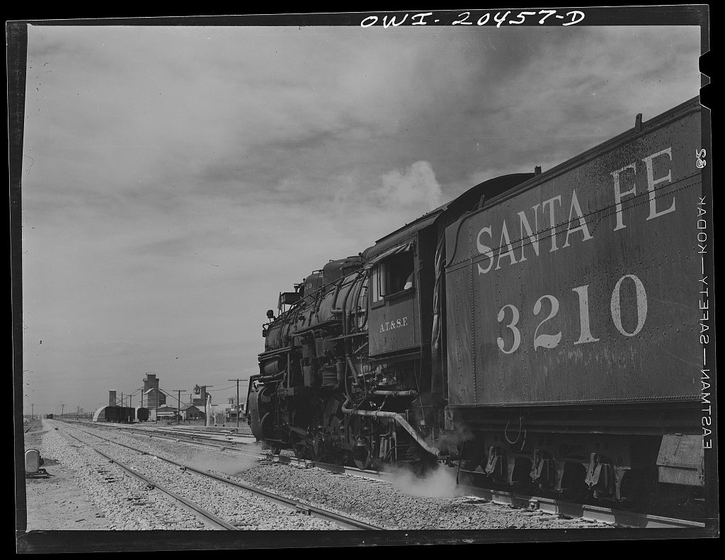Texico, New Mexico. Atchison, Topeka and Santa Fe Railroad train stopping to wait for orders to proceed to Clovis