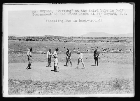 Mr. Bryand, "Putting" at the third hole in Golf Tournament on Red Cross links at Ft. Bayard, N.M. (kneeling-nun in back…