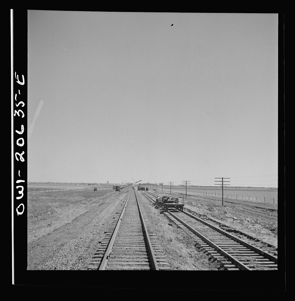Clovis, New Mexico. Passing a section gang at work on the outskirts along the Atchison, Topeka, and Santa Fe Railroad b…