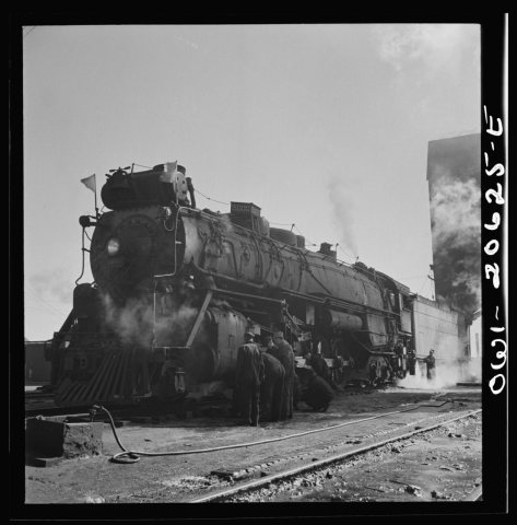 Clovis, New Mexico. Checking a locomotive as it leaves the roundhouse in the Atchison, Topeka and Santa Fe Railroad sho…