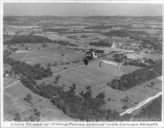 Cabin plane of Ithaca Flying Service over Cayuga Heights