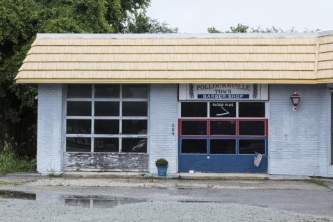 A barber set up shop in a most unlikely place, an old automobile service station