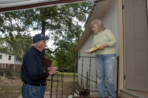 Flooding - Jacksonville, Ark. , May 16, 2011 -- A Community Relations specialist show a resident a FEMA disaster flyer.…