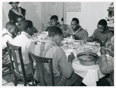 The Negro tenants and neighbors eating dinner after the whit