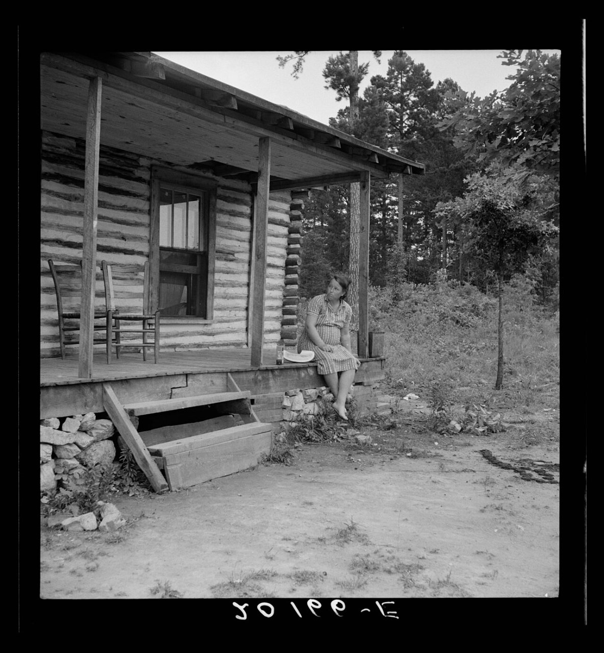 Woman sitting on cabin porch