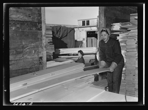 Women in essential services. Ex-fountain girl Anita Robinson unloads freight cars at the Paraffine Company