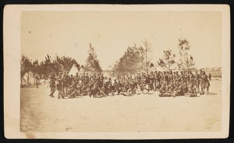 Unidentified soldiers of 43rd Massachusetts Infantry Regiment in uniform with rifles and fixed bayonets at Camp Rogers