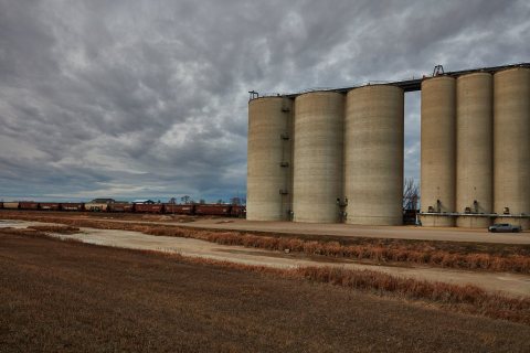 Grain cars look tiny next to these enormous silos near Ross, North Dakota