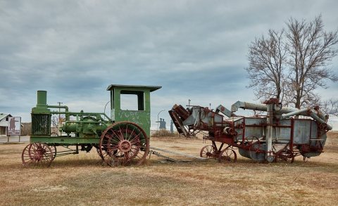 Vintage farm equipment displayed outside the Lewis & Clark Trail Museum
