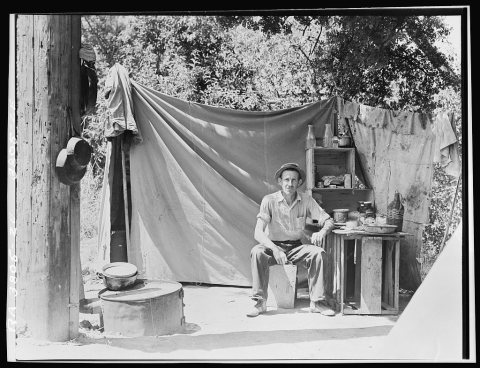 Jack Neill, "migratory fruit tramp," on banks of Pulah [Putah] Creek near Winters, California. He owns one acre subsist…