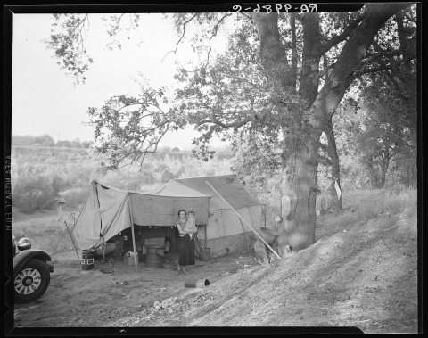 Wife and child of migrant worker, encamped near Winters, California. This is a proposed location of Resettlement Admini…