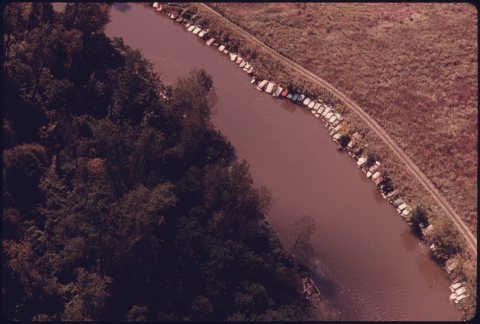 AERIAL VIEW OF OLD CARS SECURED ALONG THE BANK OF THE CUYAHOGA RIVER TO PREVENT EROSION AT JAITE NORTH OF PENINSULA... …