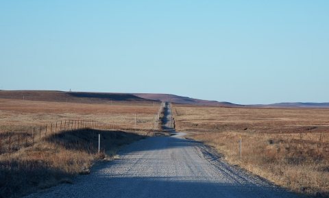 Gravel road through the Joseph H. Williams Tallgrass Prairie Preserve, owned and managed by the Nature Conservancy near…