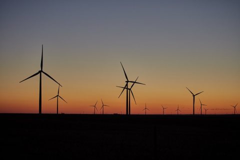 The sun sets on a "wind farm" of turbines near Burbank in Osage County, Oklahoma