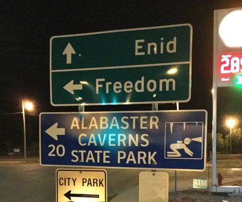 Sign pointing to Enid, Freedom, and Alabaster Caverns along highway 412