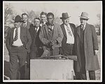 W.D. Lyons, NAACP defendant, handcuffed and standing next to six arresting officers and attorneys