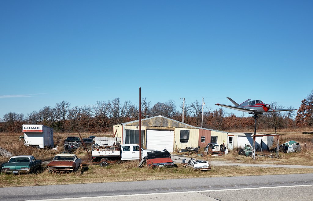 No sign outside Mannford, Oklahoma, explains what a nicely intact airplane, is doing, fittingly mounted high above the …