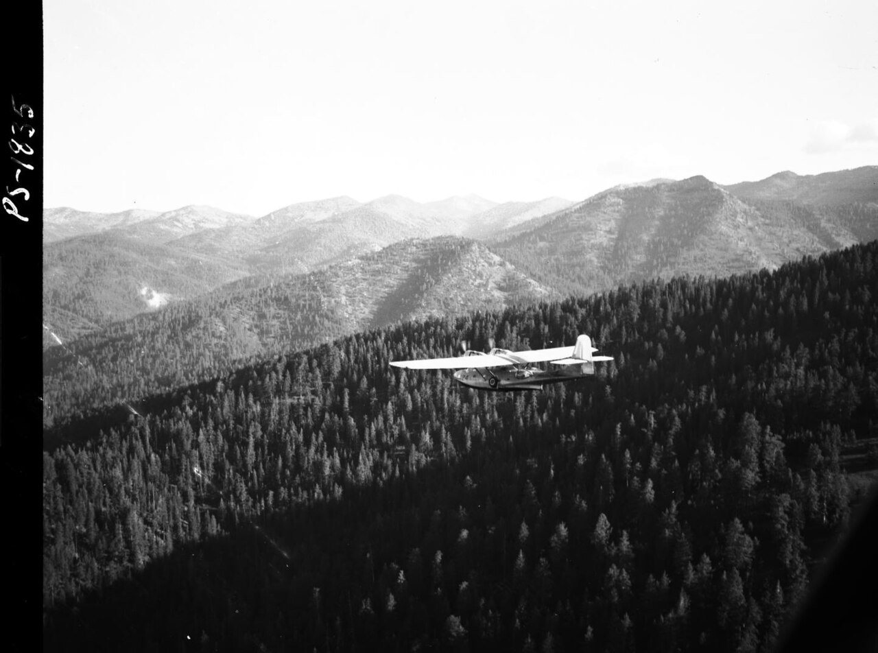 1958. PBY ferrying to spray block. Spruce budworm control project. Sumpter, Oregon
