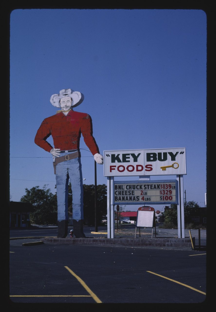 "Key Buy" Foods cowboy sign
