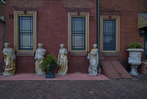 Statuary outside a beautiful, historic, and unusual Victorian-style mansion