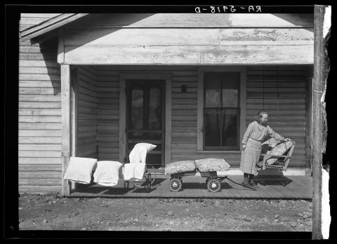 Mrs. Eargle of Fairfield airing her bedding preparatory to moving to her new home at Gardendale, Alabama