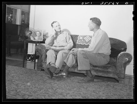 Bowman, South Carolina. Sergeant John Riley of the 25th service group, Air Service Command, at home on leave talking th…