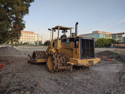 Caterpillar 815F soil compactor on site in Sunnyvale, facing right