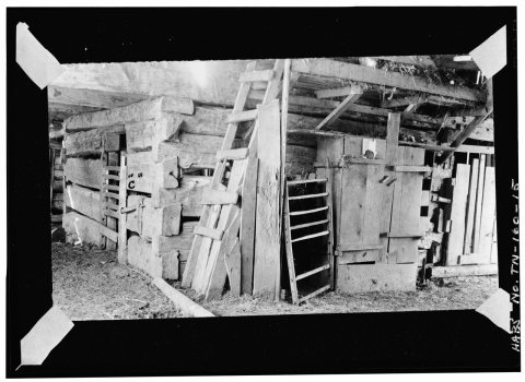 CENTER ENTRY (central area of barn), SHOWING NORTH WALL (right) OF SOUTH CENTRAL PEN WITH LADDER AND HARNESS CLOSET. NO…
