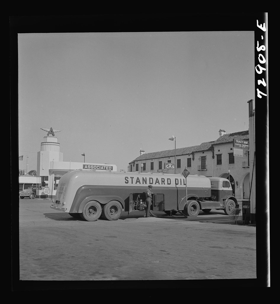 Untitled photo, possibly related to: Tracy, California. A gasoline tank truck delivering gasoline to a filling station