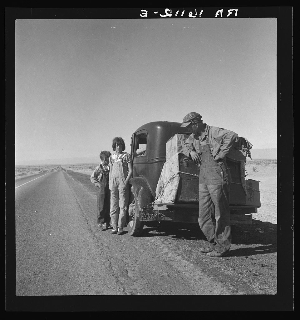 Oklahoma sharecropper and family entering California. Stalled on the desert near Indio, California