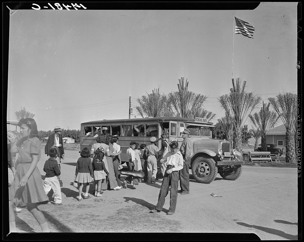 At the farmworkers' community at Indio, California, the newly-acquired school bus picks up one of its three loads of fi…