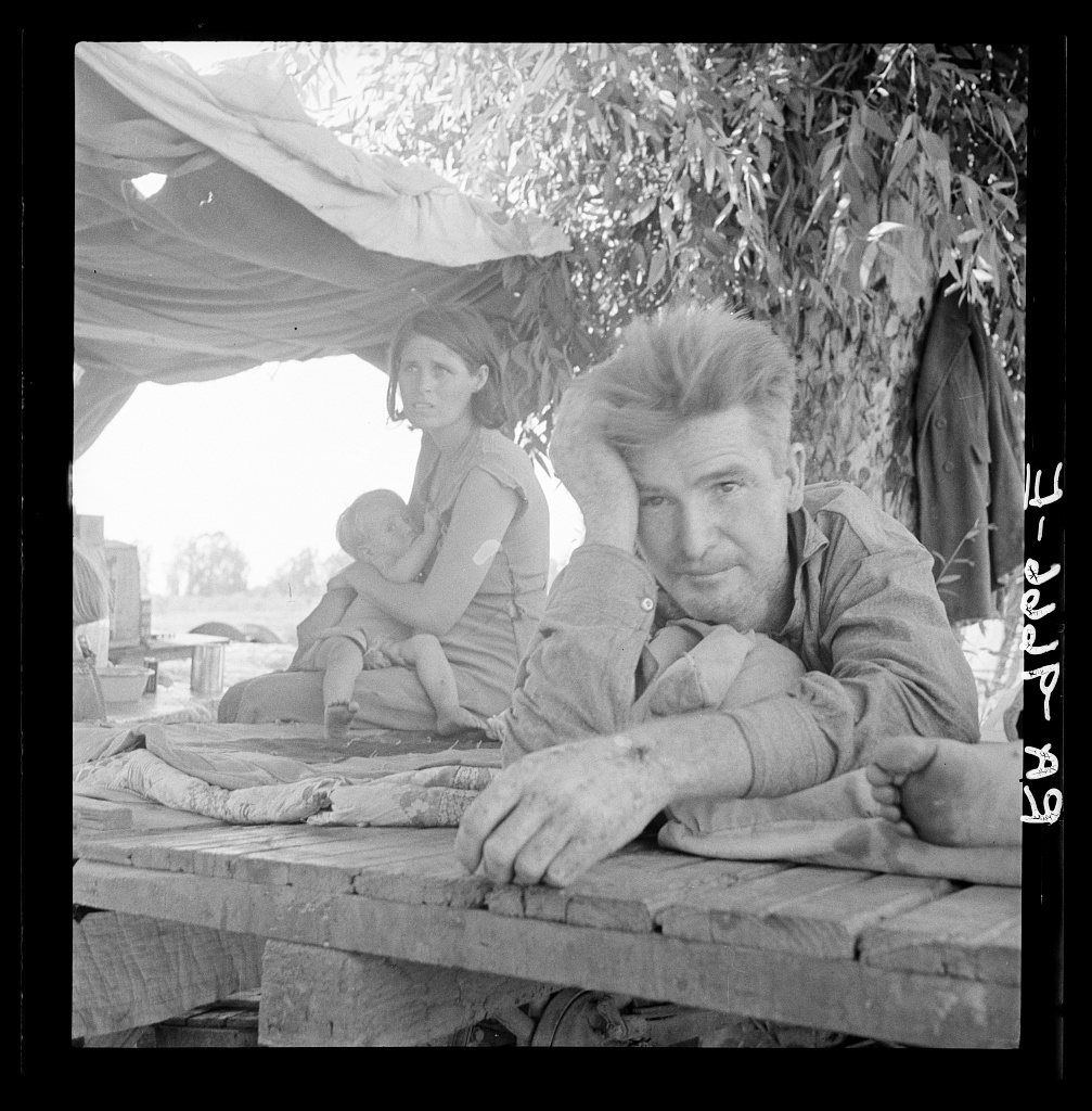 Drought refugees from Oklahoma camping by the roadside. They hope to work in the cotton fields. There are seven in fami…