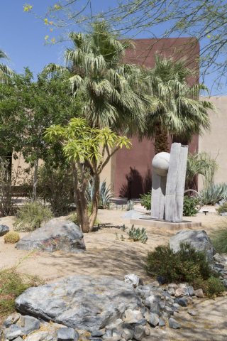 Palm trees and sculpture in the Southern California desert [Faye Sarkowsky Sculpture Garden]