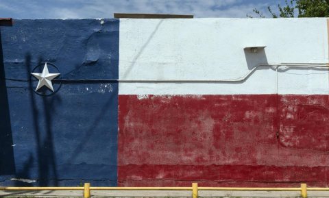 A wall colorfully painted with the likeness of the Texas flag, complete with a 3-D star, in the little town of Asherton…