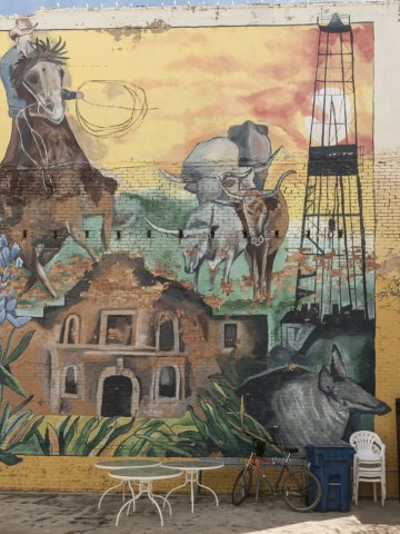 Large mural on an exterior wall of the building housing the Log Cabin Collectibles store in downtown