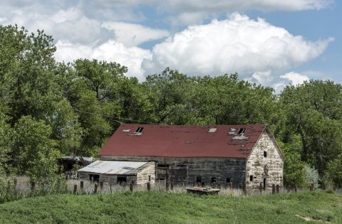 Weathered and damaged old barn in rural Pueblo County, Colorado, near the little railroad settlement of