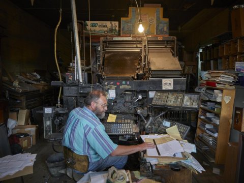 In the tiny, cluttered offices of the weekly Saguache Crescent newspaper, publisher Dean Coombs still sets type the VER…