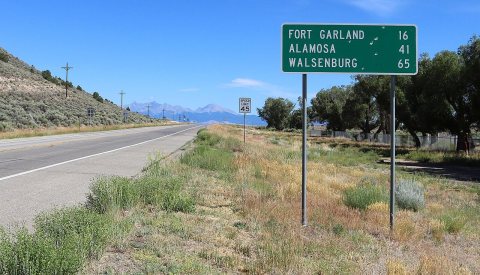 Distance road sign on Colorado State Highway 159
